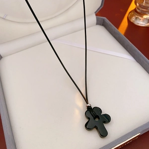 Detailed view of flower-shaped pendant in luxury jewelry box with elegant lighting