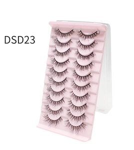 Close-up of 10 pairs of dense curly false eyelashes on a pink tiered display stand