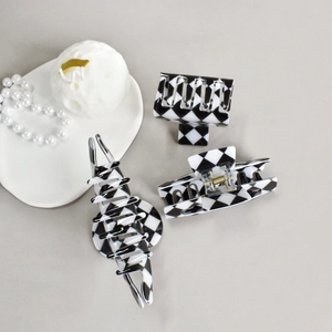 Detailed view of 3-piece black and white checkered acetate hair claw clips set