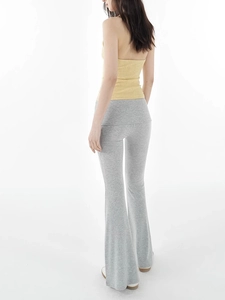 Close-up of a yellow knitted halter top with cross V-neck and open back for women