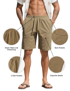Detail view of khaki sports shorts showing elastic waistband, drawstring and side pockets