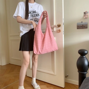 Close-up of pink tote bag showing unique pleated fabric texture and minimalist style