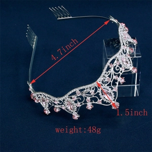 Close-up of silver bridal crown with pink crystals, measuring 4.7 inch wide and 1.5 inch high