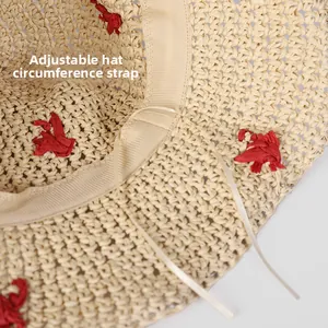 Detail view of adjustable strap and sweatband inside the beige straw sun hat