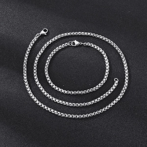 Detail of silver stainless steel box chain necklace and bracelet with lobster clasps