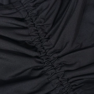 Macro detail of black knitted fabric featuring professional ruched and pleated design