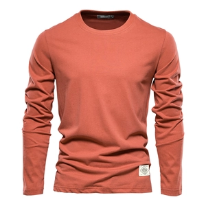 Close-up of terracotta cotton long sleeve T-shirt with reinforced cuffs and hem logo