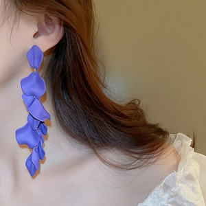 Detail of long purple resin flower petal tassel earrings shown on a model side profile
