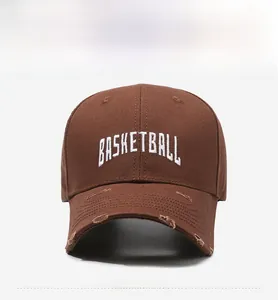 Detail of dark brown distressed baseball cap with white basketball embroidery art