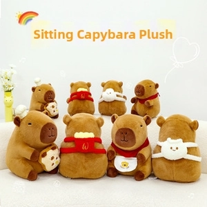 Close-up of sitting capybara plush toys featuring chef hats and tiny embroidered backpacks