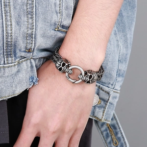 Macro shot of punk skull head detail on silver titanium steel chain bracelet for men