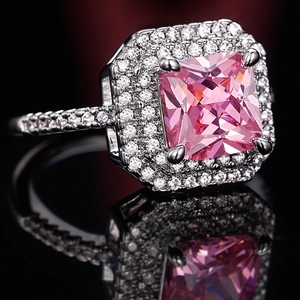 Luxury princess cut pink zircon ring with double halo pavé setting on black background