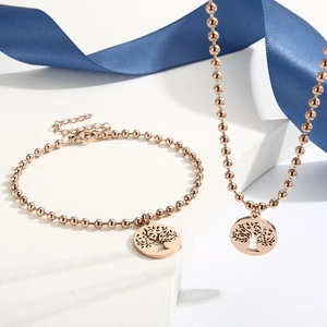Set gioielli albero della vita oro rosa con collana e bracciale su pietra bianca