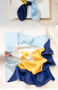 Detail of elegant navy and light blue silk scarf with geometric pattern for women