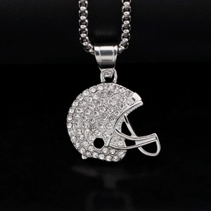 Macro detail of iced-out silver American football helmet pendant with silver bead chain