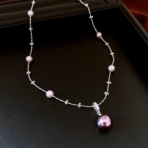 Detail of French style purple pearl necklace with zircon and silver adjustable chain