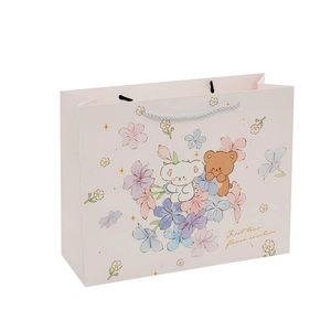 Pink cartoon gift bag with bear and flower illustrations and white braided handles
