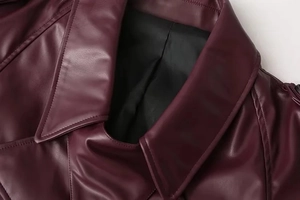 Close-up of vintage lapel collar and premium stitching on burgundy faux leather jacket