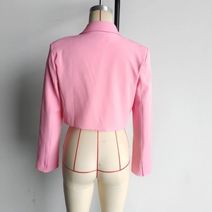 Back view of a pink short-fitted blazer jacket on a mannequin showing seam detail