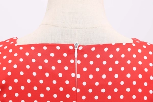 Detail of the hidden back zipper on a vintage red polka dot dress for women