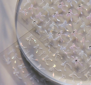 Macro view of holographic butterfly nail art stickers with crystal rhinestones
