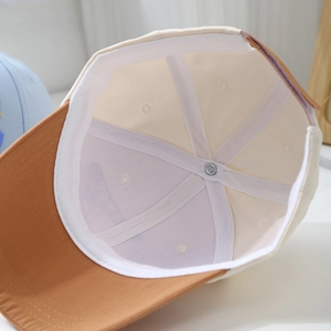 Detailed interior of kids' baseball cap showing mesh structure and reinforced stitching