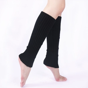 Close-up of black ribbed knit leg warmers showing elastic texture and fit on legs