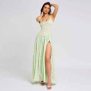Detail of light green jacquard maxi dress with high slit and slim waist tailoring