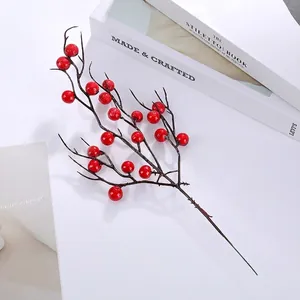 Top view of vibrant red artificial holly berry branches for home holiday decor