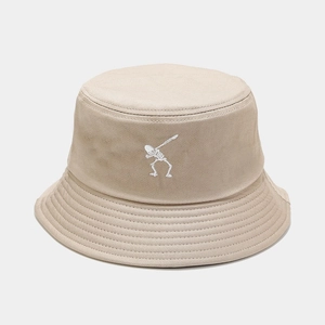 Detailed close-up of white skeleton dab embroidery on a beige cotton twill bucket hat