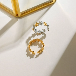 Detailed macro shot of two-tone and gold star-shaped open rings with metallic finish
