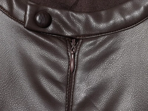 Detail of round neckline and matching buttons on dark brown PU leather dress