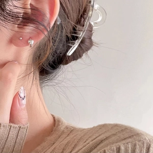 Minimalist 925 sterling silver heart earrings and hair clip worn by a model