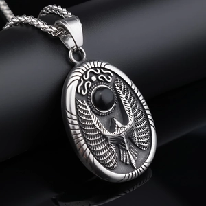 Macro shot of vintage silver stainless steel eagle pendant with black onyx gemstone inlay