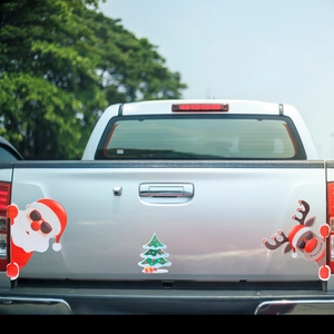 Detail of Christmas magnetic car stickers featuring Santa, tree, and reindeer with reflective finish