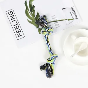 Macro shot of a durable blue and yellow knotted cotton rope toy for dogs in home setting