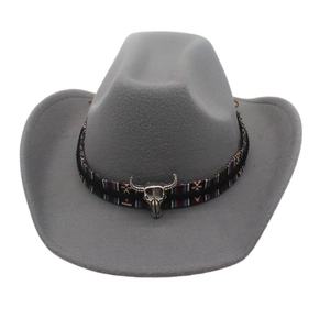 Grey western cowboy hat with ethnic woven band and silver bull skull ornament