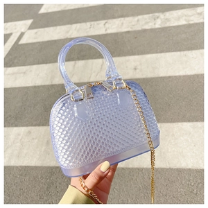 Close-up of blue PVC jelly handbag with diamond texture and gold chain strap