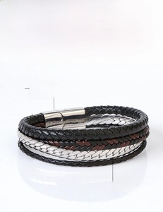 Detail of vintage multilayer braided leather bracelet with stainless steel magnetic clasp
