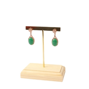 Rose gold earrings with green oval stones and crystals displayed on a jewelry stand