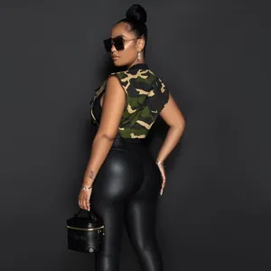 Detail of a camouflage cargo vest paired with sleek black faux leather pants in a chic look