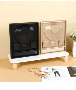 Detail of professional jewelry display set in black and champagne gold for necklaces