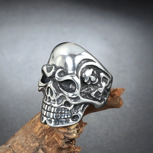 Men's gothic stainless steel skull ring with vintage silver finish on wood background