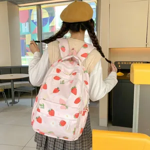 Pink canvas backpack with strawberry print featuring adjustable straps for students