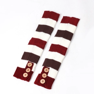 Detail of knitted leg warmers with burgundy stripes and decorative wooden buttons