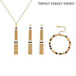 Detail view of gold titanium steel jewelry set with black agate beads and tiered chains