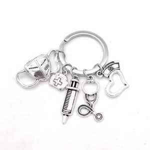 Silver medical keychain with N95 mask, stethoscope, syringe and nurse hat charms