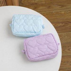 Set of two candy-colored quilted heart makeup bags in light blue and lavender silk finish