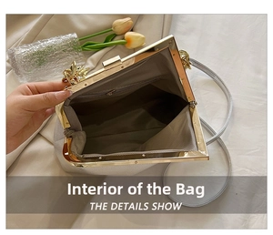 Internal view of white leather handbag showing interior pocket and metal gold closure