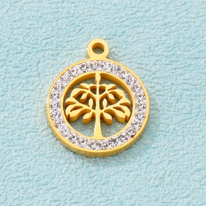 Close-up of golden hollow Tree of Life pendant with sparkling zircon accents